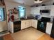 Efficient kitchen featuring white cabinets, black appliances, and marble countertops at 1336 E Schwartz Blvd, Lady Lake, FL 32159