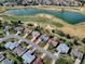 Aerial view of the home in a neighborhood with golf course and lake. Highlighted in red outline at 1377 Eagle Ridge Dr, The Villages, FL 32162