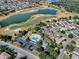 Aerial view of a residential community on a golf course with beautiful tree coverage and lake views at 1377 Eagle Ridge Dr, The Villages, FL 32162