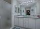 Bathroom featuring a glass enclosed shower and a double vanity with lots of storage at 1377 Eagle Ridge Dr, The Villages, FL 32162
