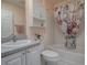 Cozy bathroom with a shower, a white cabinet above the toilet, and a sink with gray countertops at 1377 Eagle Ridge Dr, The Villages, FL 32162