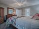 Inviting bedroom with warm lighting, an open doorway, and dark wood furniture at 1377 Eagle Ridge Dr, The Villages, FL 32162