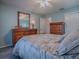 Well-lit bedroom showcasing a beautiful dresser with a large mirror at 1377 Eagle Ridge Dr, The Villages, FL 32162