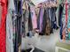 Organized closet showcasing an array of colorful clothes hanging neatly with some visible shoes and bags at 1377 Eagle Ridge Dr, The Villages, FL 32162