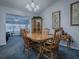 Cozy dining room with wood table set, chairs, and a decorative hutch and artwork at 1377 Eagle Ridge Dr, The Villages, FL 32162