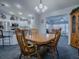 Inviting dining room with wood table, chairs, and a view into the living and kitchen area at 1377 Eagle Ridge Dr, The Villages, FL 32162