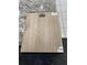 Close-up showcasing Mohawk RevWood flooring sample on granite countertop with tile at 1377 Eagle Ridge Dr, The Villages, FL 32162
