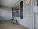 Inviting front porch featuring a charming table and chairs for relaxing outdoors at 1377 Eagle Ridge Dr, The Villages, FL 32162