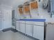 Garage featuring white storage cabinets with a blue countertop for a clean and organized look at 1377 Eagle Ridge Dr, The Villages, FL 32162