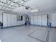 Large garage featuring epoxy floors, built-in storage cabinets and a ceiling fan at 1377 Eagle Ridge Dr, The Villages, FL 32162