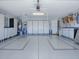 Organized garage featuring storage cabinets and accessories, with well-maintained epoxy floors at 1377 Eagle Ridge Dr, The Villages, FL 32162