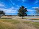 Picturesque view of the golf course, featuring lush green grass, sand traps and a tranquil lake at 1377 Eagle Ridge Dr, The Villages, FL 32162
