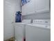 Well-equipped laundry room features modern white washer and dryer, and convenient storage cabinets at 1377 Eagle Ridge Dr, The Villages, FL 32162