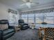 Relaxing living room featuring comfortable seating, large windows, and plenty of natural light at 1377 Eagle Ridge Dr, The Villages, FL 32162