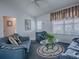 Warm living room featuring comfortable seating, a decorative rug, and a ceiling fan at 1377 Eagle Ridge Dr, The Villages, FL 32162