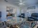 Relaxing living room with comfortable seating, a glass table, and views to the dining area at 1377 Eagle Ridge Dr, The Villages, FL 32162