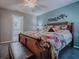 Inviting primary bedroom with wood accents, a decorative headboard, and a leather bench at 1377 Eagle Ridge Dr, The Villages, FL 32162