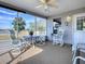 Screened patio with comfortable seating offers panoramic views of the lush outdoor landscape at 1377 Eagle Ridge Dr, The Villages, FL 32162