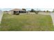 Large backyard with a view of the home's screened-in patio and a white vinyl fence at 140 Lake Catherine Cir, Groveland, FL 34736