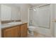 Bathroom featuring a tub shower with glass doors, tile flooring, and a granite vanity at 140 Lake Catherine Cir, Groveland, FL 34736