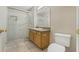 Bathroom featuring a glass-enclosed shower, granite countertop vanity, and tile flooring at 140 Lake Catherine Cir, Groveland, FL 34736