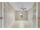 Bedroom with bright neutral walls, tile floors, a ceiling fan, and double french doors at 140 Lake Catherine Cir, Groveland, FL 34736