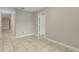 Neutral toned bedroom with tile floors and base molding featuring access to hallway at 140 Lake Catherine Cir, Groveland, FL 34736