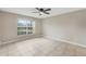 Bright and spacious bedroom with large window, tiled flooring, and neutral walls at 140 Lake Catherine Cir, Groveland, FL 34736