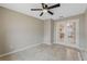 Bedroom with tile floors, neutral walls, ceiling fan, and french doors to the exterior at 140 Lake Catherine Cir, Groveland, FL 34736