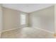 Bedroom with bright neutral walls, tile floors, and a window with a view to the outdoors at 140 Lake Catherine Cir, Groveland, FL 34736