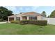 A single story home with a well maintained front lawn, landscaping, and a two car garage at 140 Lake Catherine Cir, Groveland, FL 34736