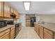 Kitchen featuring a large island, stainless steel appliances, granite counters, and tile flooring at 140 Lake Catherine Cir, Groveland, FL 34736