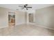 Expansive living area with tile flooring seamlessly connecting to the open kitchen and multiple rooms at 140 Lake Catherine Cir, Groveland, FL 34736