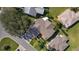 Overhead view of roof, circular driveway design, and mature landscaping and lawn at 1508 Lakewood Dr, The Villages, FL 32162