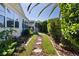 Landscaped backyard featuring a stone path leading to a cozy seating area, perfect for outdoor relaxation at 1508 Lakewood Dr, The Villages, FL 32162