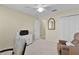 Bedroom with a chair, closet, and mirror. Light streams in from an open door at 1508 Lakewood Dr, The Villages, FL 32162