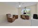 Bedroom featuring a desk with a chair, a window, and an armchair at 1508 Lakewood Dr, The Villages, FL 32162