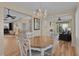 Dining area with chandelier open to living spaces at 1508 Lakewood Dr, The Villages, FL 32162