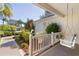 Relaxing front porch featuring a cozy swing, complemented by lush landscaping, offering a serene outdoor space at 1508 Lakewood Dr, The Villages, FL 32162