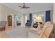 Comfortable living room showing modern TV and a side glimpse of a connected kitchen and dining area at 1508 Lakewood Dr, The Villages, FL 32162