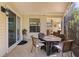 Covered patio with wicker furniture, a ceiling fan, and a view into the sunroom at 1508 Lakewood Dr, The Villages, FL 32162