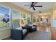 Cozy sunroom seating area with views of the landscaped yard and dining room at 1508 Lakewood Dr, The Villages, FL 32162