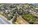 Panoramic aerial view showing homes near a highway, complemented by green fields and trees for a perfect balance at 15307 Petrus Ln, Clermont, FL 34714