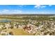 Scenic aerial view of a residential area, highlighting a charming home with a large, green lot at 15307 Petrus Ln, Clermont, FL 34714