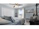 Comfortable bedroom with white closet doors, gray walls, and a large window with natural light at 15307 Petrus Ln, Clermont, FL 34714