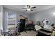 Multi-purpose room with office and exercise equipment, neutral carpeting, and a ceiling fan at 15307 Petrus Ln, Clermont, FL 34714