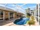 Beautiful screened-in pool area with stone edging and lush landscaping, perfect for outdoor relaxation at 15307 Petrus Ln, Clermont, FL 34714