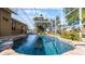 Relaxing screened-in pool with rock accents, surrounded by lush greenery for a tranquil escape at 15307 Petrus Ln, Clermont, FL 34714