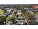 An aerial view of the property and neighborhood showcasing nearby amenities and green spaces at 1623 W Schwartz Blvd, The Villages, FL 32159