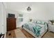 Bright bedroom featuring a decorative ceiling fan, stylish bedding, and wood-look flooring at 1623 W Schwartz Blvd, The Villages, FL 32159